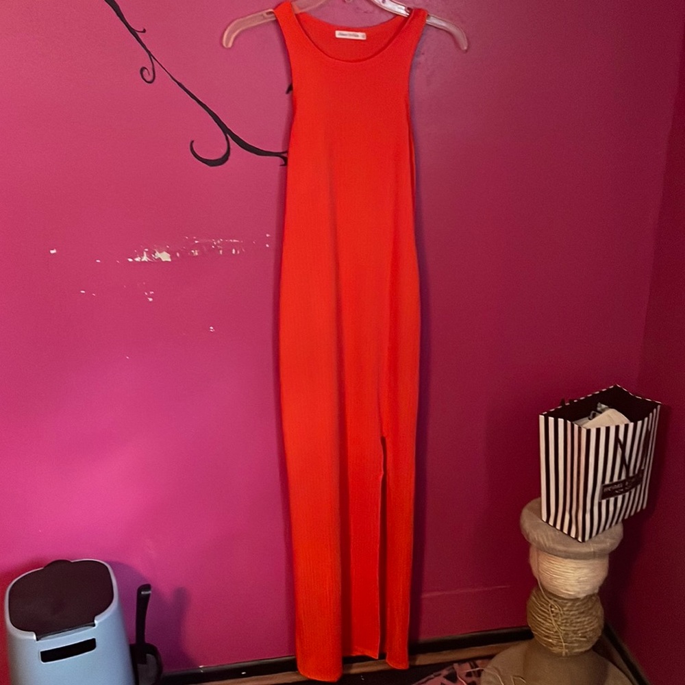 Orange maxi dress fitted at the hips and more flare at the bottom